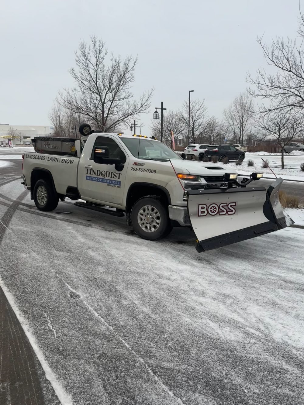 Lindquist Outdoor Services branded plow truck